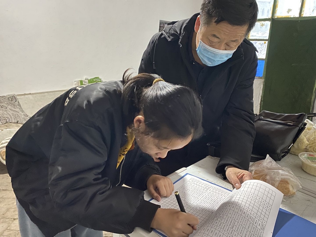 受助生尹雪芹在家中填写签领表.jpg